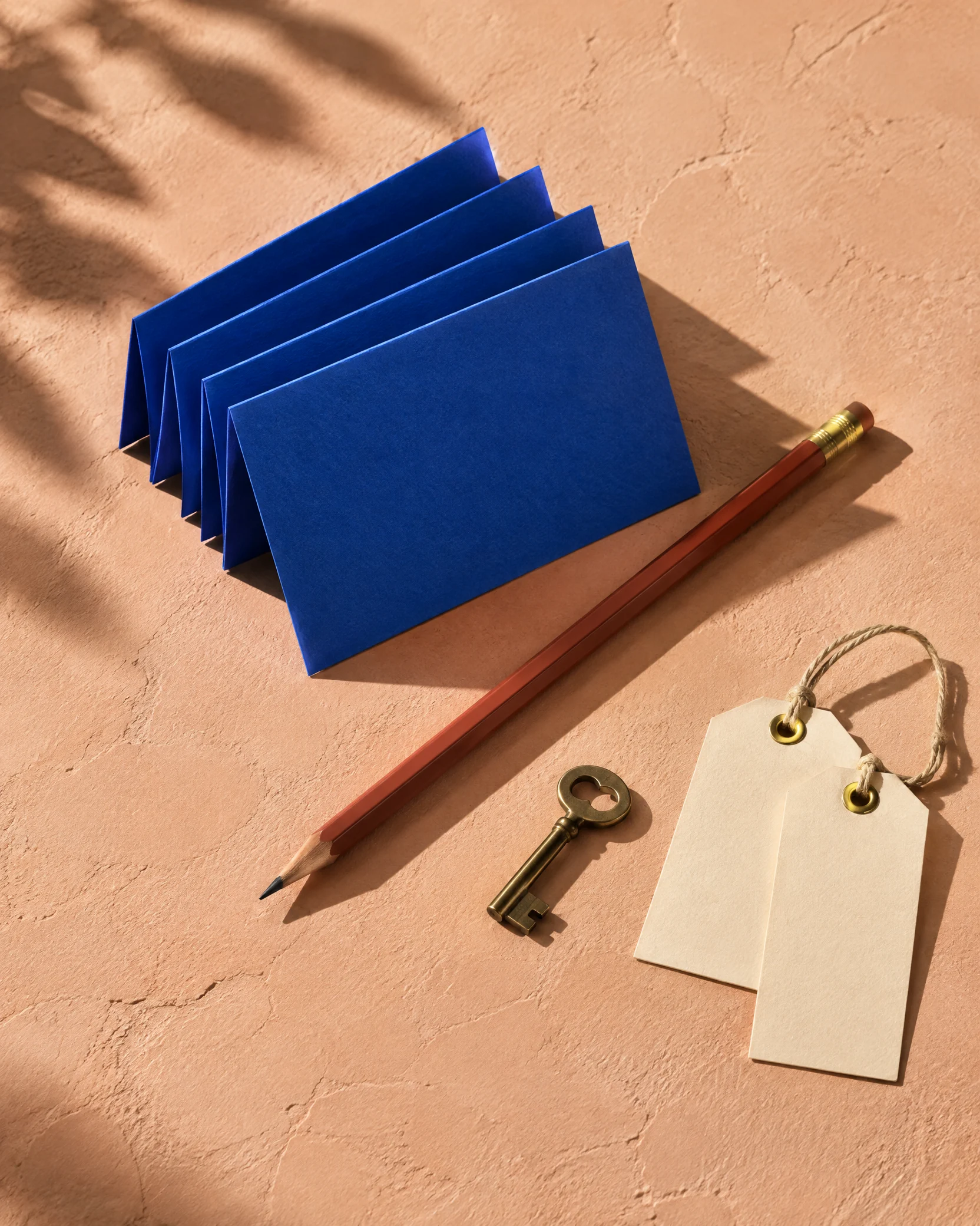 Cobalt index cards, key and tags on a peach surface